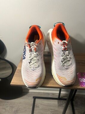 Hoka White Shoes with Orange Lining and Blue Logo